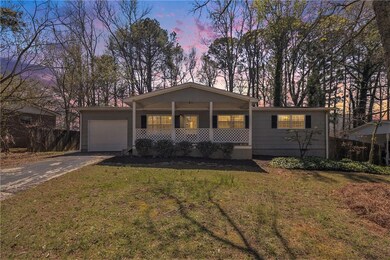 Single story home with covered porch, an attached 