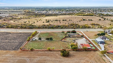 Aerial view of sparsely populated area featuring property boundaries highlighted