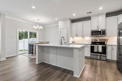 Kitchen featuring pendant lighting, an island with