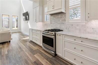 The gorgeous stove is gas with a the gorgeous coun