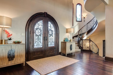 Breathtaking Entry featuring 21 Foot Ceilings and Spiral Staircase from 2nd Floor to Basement