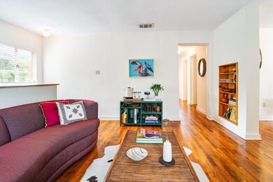 Living area with wood finished floors and baseboa