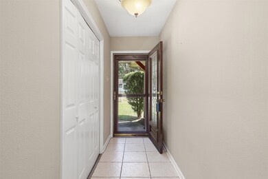 Entryway with screen door. Flex room is to the left