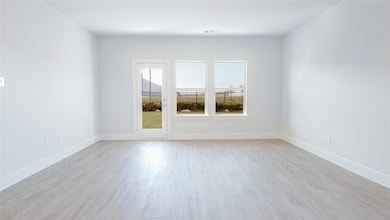 Unfurnished room with light hardwood / wood-style 
