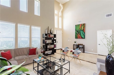 Living area with light tile patterned floors, a hi