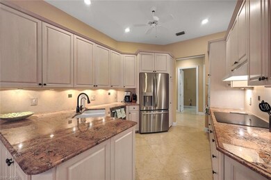 Kitchen with sink, ceiling fan, appliances with st