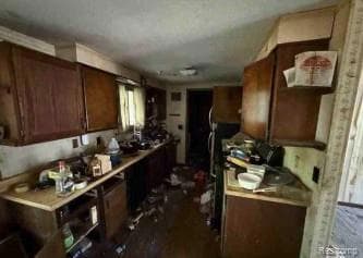 Kitchen with dark brown cabinetry and light countertops