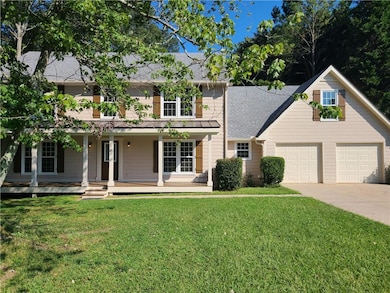 View of front of property featuring freshly painted home with 2 car garage, elongated driveway and front of yard