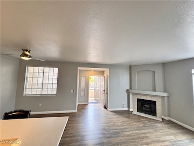Unfurnished living room featuring a ceiling fan, a