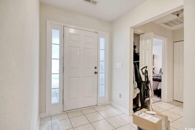 Foyer entrance featuring light tile patterned floo
