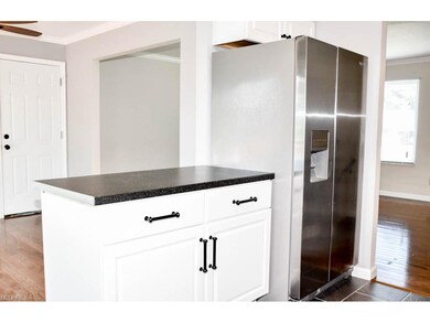 The kitchen looks over into the dining room.