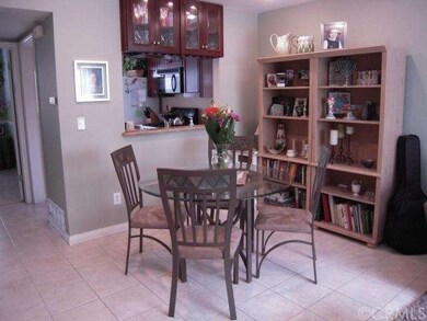 The dining area features a tile floor, recessed li