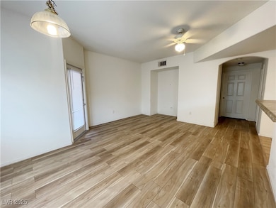 Spare room with light wood-type flooring, a ceilin