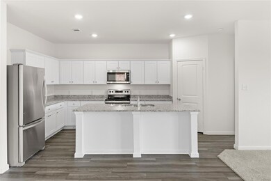 Kitchen with white cabinets, a center island with 