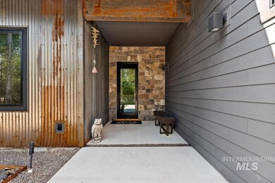 Doorway to property with stone siding