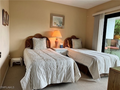 Carpeted bedroom featuring baseboards and access t