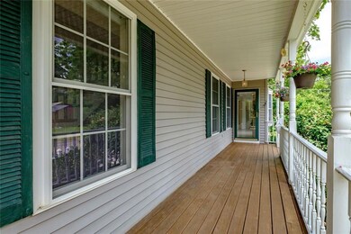 Front porch perfect for hanging plants.