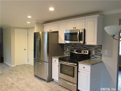 Kitchen. ALL NEW STAINLESS APPLIANCES, GRANITE AND DESIGNER BACKSPLASH PLUS BEAUTIUFL CERAMIC FLOORING....