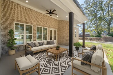 Enjoy outdoor living year-round on this charming covered patio featuring a ceiling fan, spacious seating area, and peaceful views. Perfect for morning coffee, evening gatherings, or simply unwinding in your own backyard retreat.