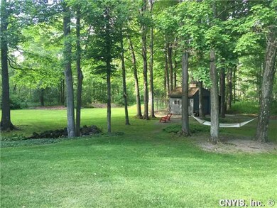 Backyard. Landscaping and gardens throughout. Shed