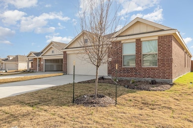 Ranch-style home featuring a front lawn, concrete 
