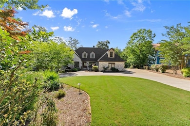 New england style home featuring stone siding and a front yard