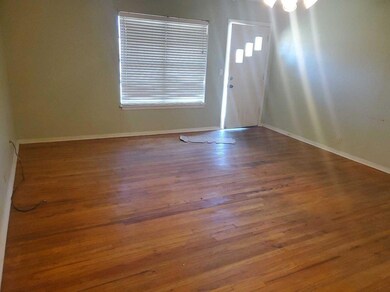 Foyer with baseboards and wood finished floors