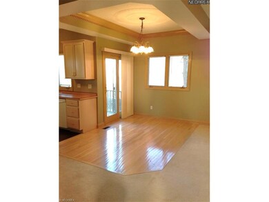 Wood floors, tray ceiling and doors leading to the