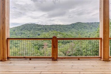 Wooden deck with a view of trees and a mountain view