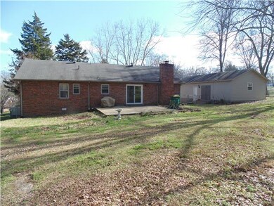 Back view of home showing patio and detached two car garage