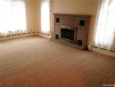 Living Room. Log Fireplace with heatalater all Window Treatments stay