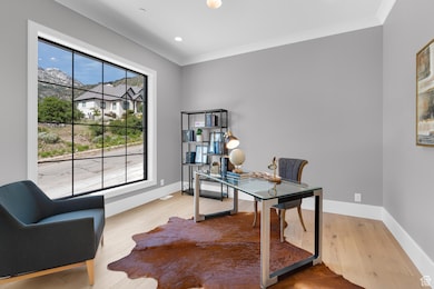Office featuring crown molding, wood finished floors, baseboards, and recessed lighting