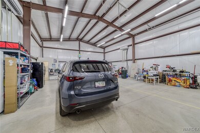 Garage featuring metal wall and freestanding refri