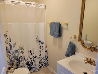 Full bathroom with vanity, a shower with shower curtain, and tile patterned flooring