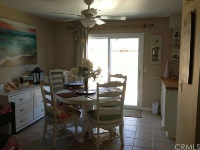 Large eating area with new ceiling fan and light.