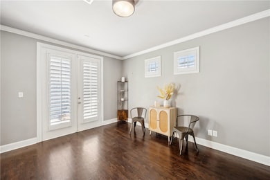 Sitting room featuring crown molding, wood finishe