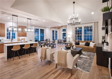 Living room with a notable chandelier, light hardw