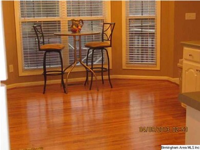 PRETTY BREAKFAST NOOK WITH BAY WINDOW AND HARDWOOD