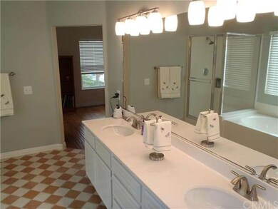 Master bathroom with dual sinks and new light and plumbing fixtures