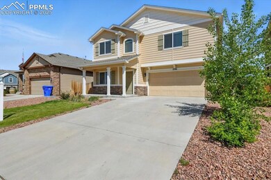 View of front of home featuring a porch, stone siding, a garage, and concrete driveway