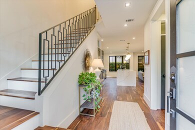 Entryway with wood finished floors, stairway, and