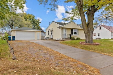 Beautiful concrete driveway and extra parking strip to the side with a huge 2 car garage!