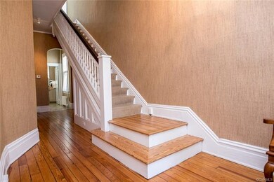 Entrance Hall has wonderful open staircase and leads to the rear of the home.