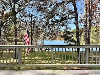Wooden terrace with a water view and a lawn