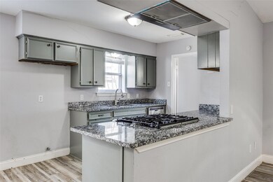 Kitchen with sink, kitchen peninsula, stone counte