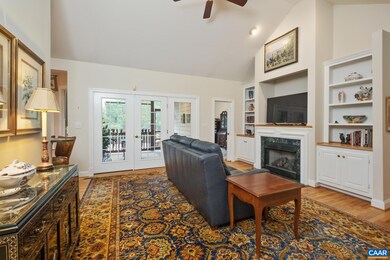 The living room features a cathedral ceiling, view