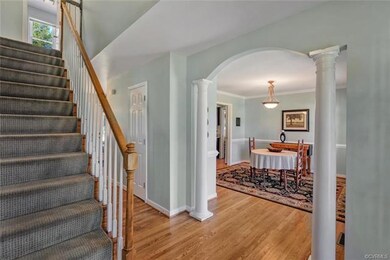 Nice curved doorway and columns make a grand entrance to the large dining room!
