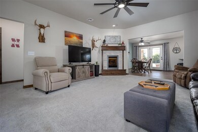 Living room featuring ceiling fan and carpet floor