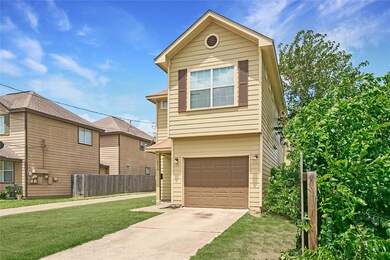 View of front of property with driveway and an at