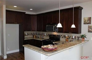 Kitchen features breakfast bar counter, granite co